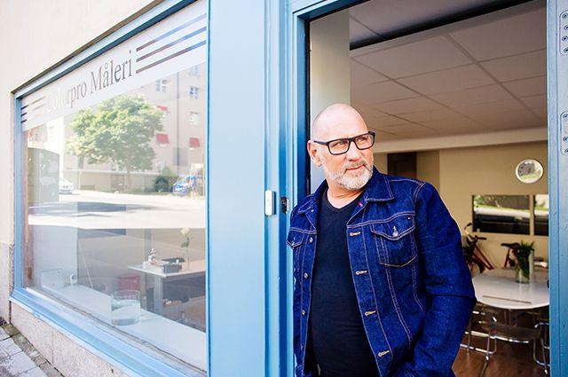 Ägaren Magnus Nordahl för Colorpro står framför sin målarbutik iklädd jeansjacka